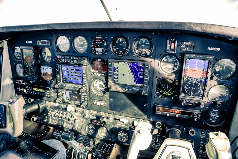 a cockpit with multiple different control screens on the screen