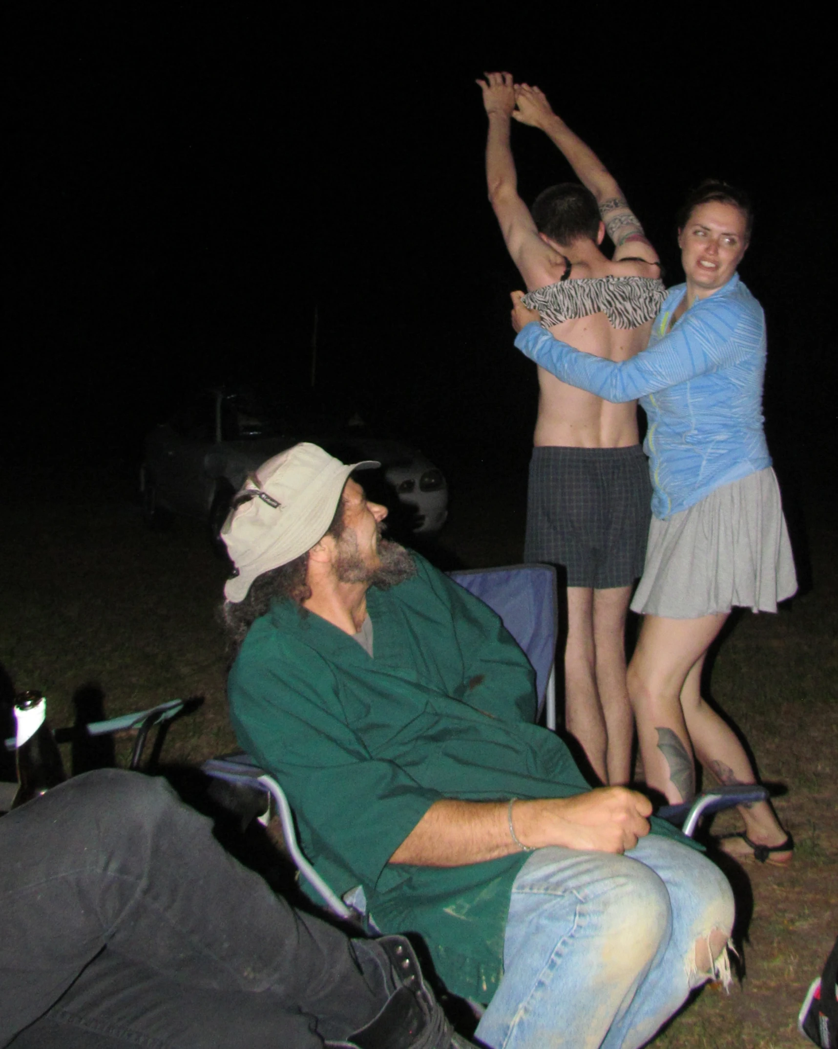 a group of people outside and one man holding up a frisbee