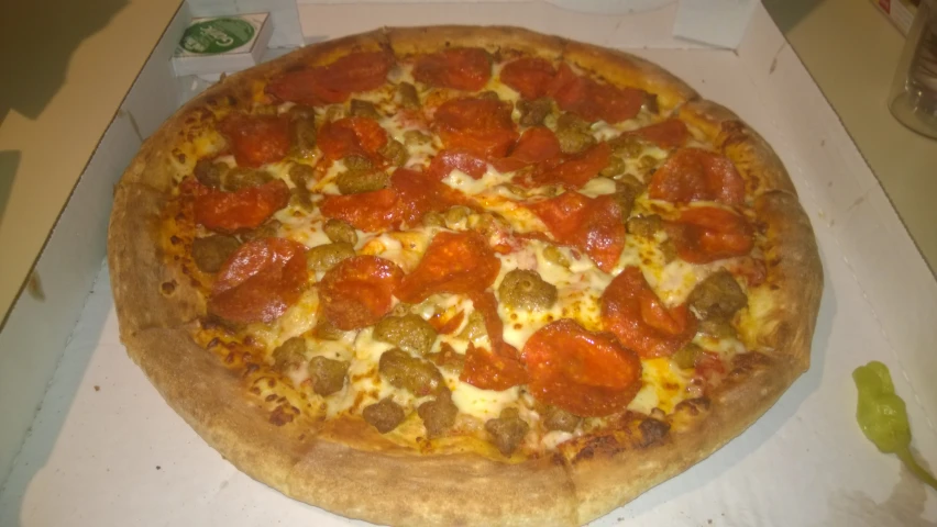 a close up of a large pizza sitting on a table