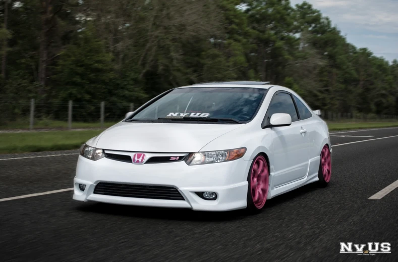 the white and pink honda civic civic civic civic is going down a highway