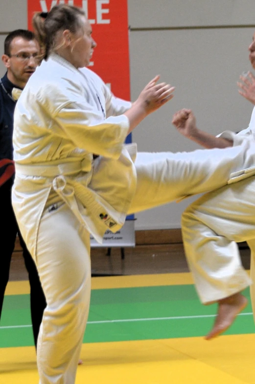 the two people are fighting in a karate match