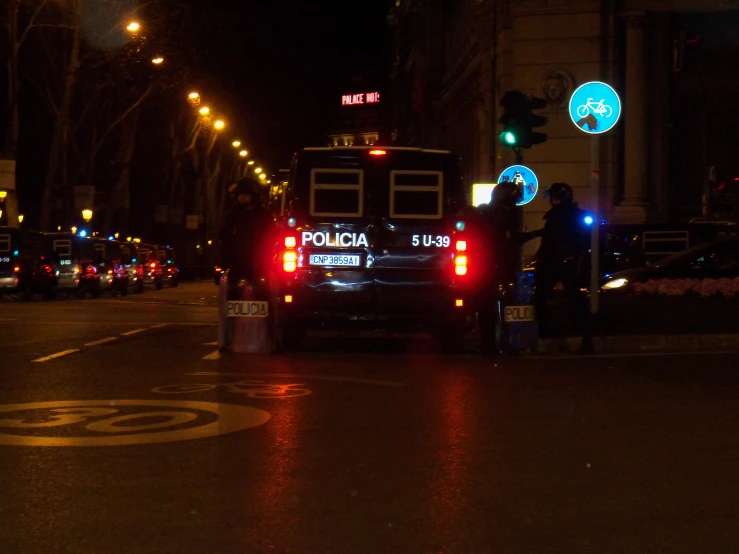 a police truck parked next to a city street at night