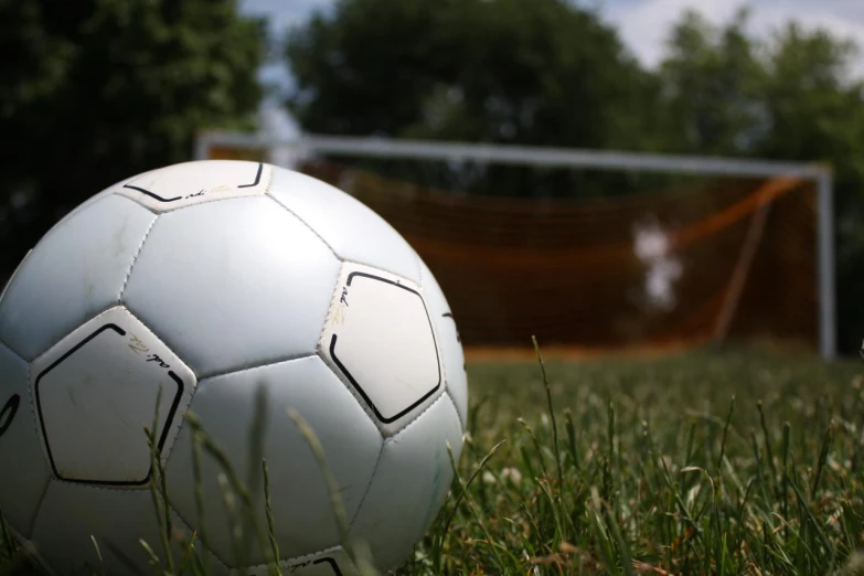 the soccer ball is on the green field