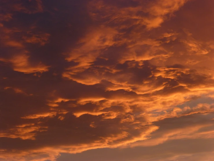 a sunset is shown with red clouds above