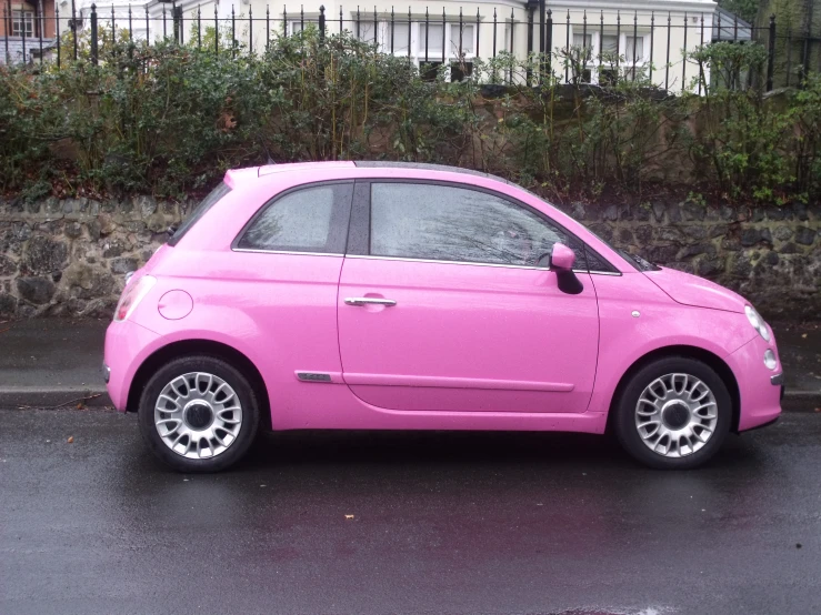 a car in pink parked on the street