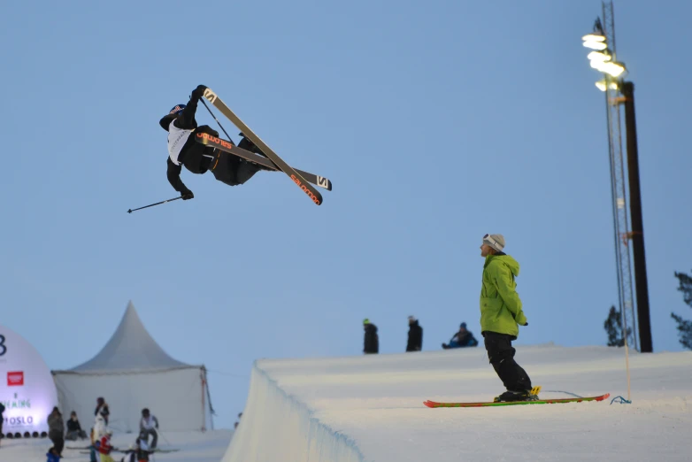 a skier jumping in the air with his skis up in the air