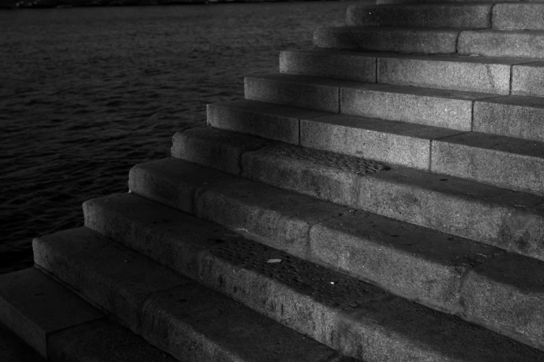 an image of a set of stone steps that lead to the water