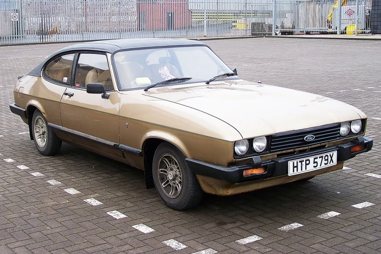 a brown car parked in a parking lot