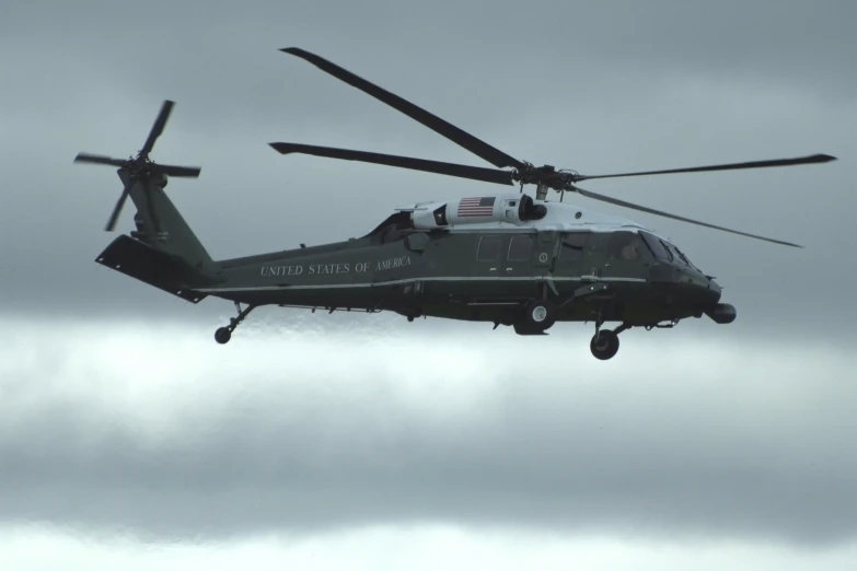 a military helicopter flies through the air