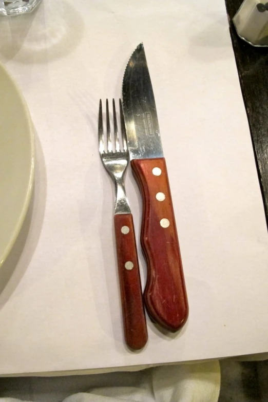 a silver knife and fork sitting on a napkin
