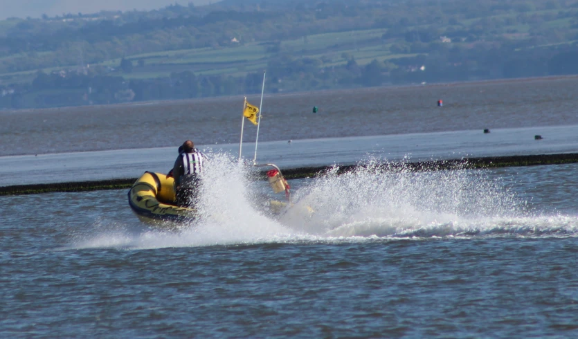 a person being pulled along in a boat on the water