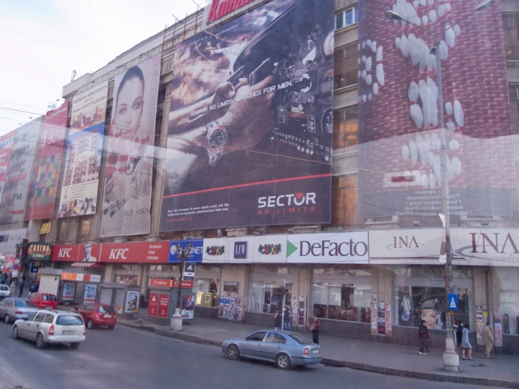 a big building in the city has a huge poster on it