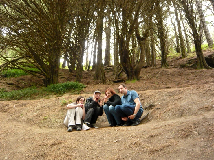 a family poses for a pograph on top of a hill