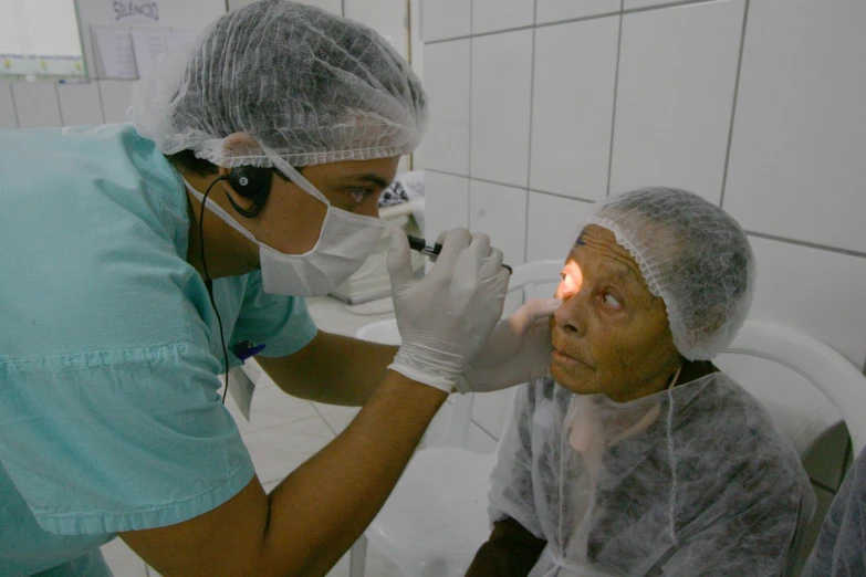 a nurse is helping a patient who is wearing protective clothing