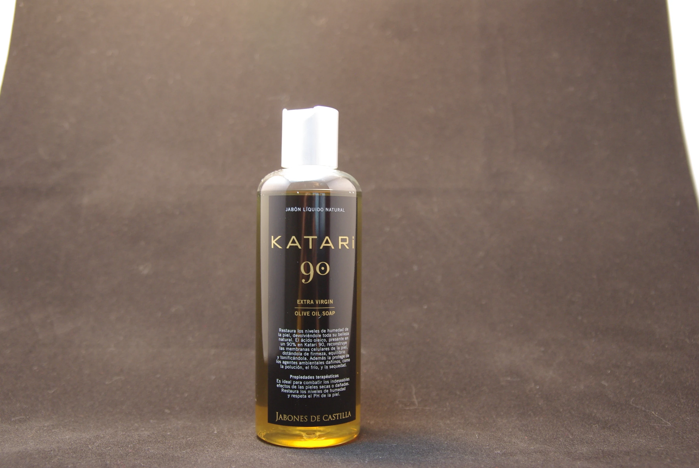 a bottle of kaat hair oil sitting on top of a brown surface