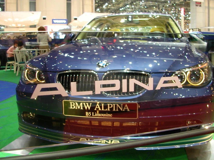 a blue and black car on display at a show