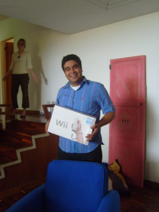 the man holds up a sign that reads wii