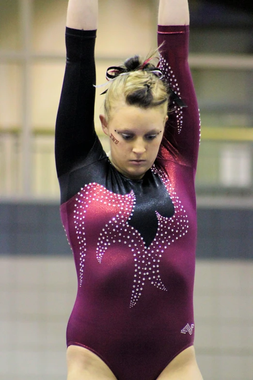 girl performs a routine on the beam during an olympic gymnastics event