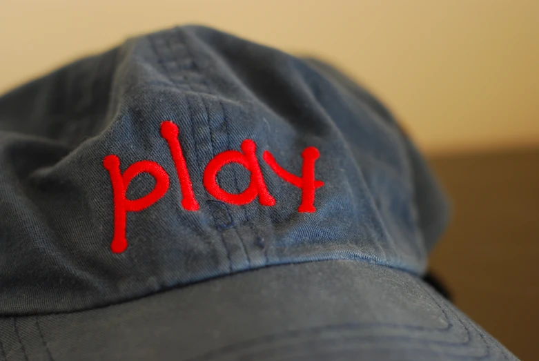 the cap has the word play embroidered on it