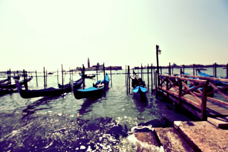 many watercraft docked at the end of a pier