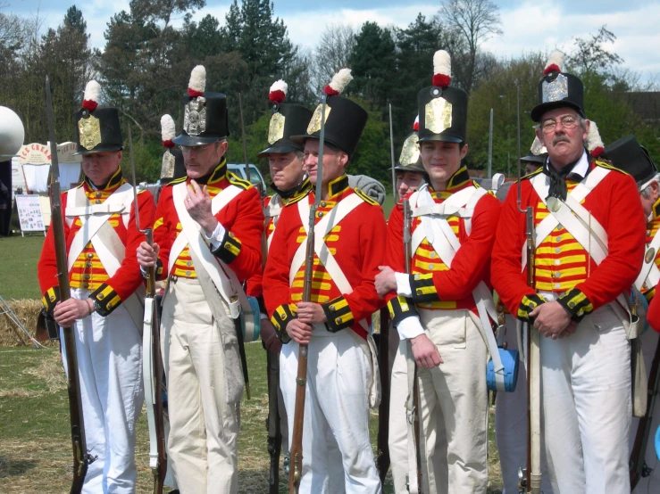 a group of people wearing uniform and singing