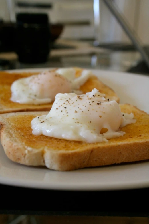 two pieces of bread topped with cheese and eggs