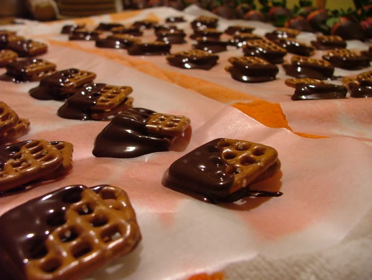 chocolate pretzels sitting on top of white table cloth