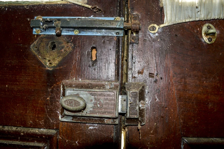 an old wooden door with ss handles and lock