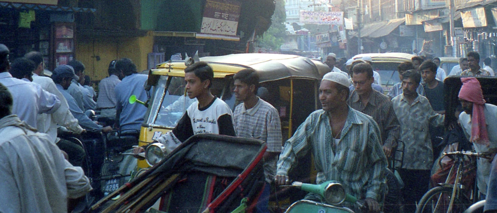 the men are walking through the busy street