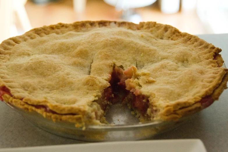 a pie that is cut into pieces on a table