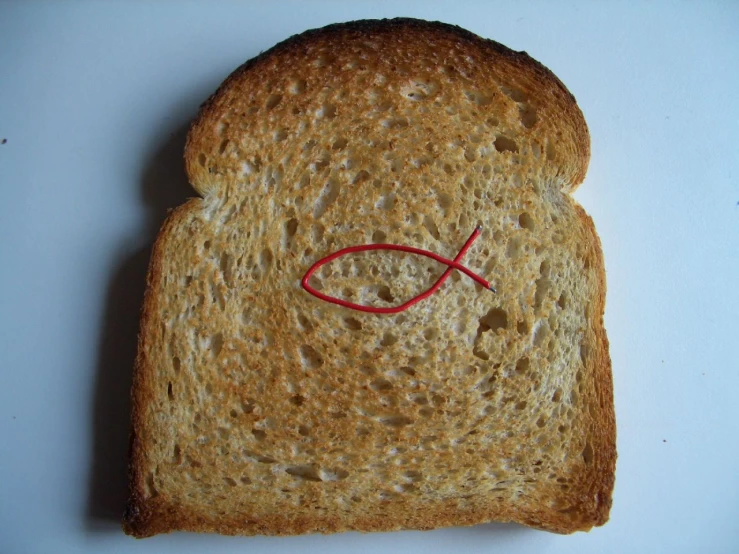 a peanut er and jelly sandwich with a small fish drawn on it