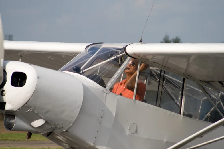 a man sitting in an airplane window as it checks the view