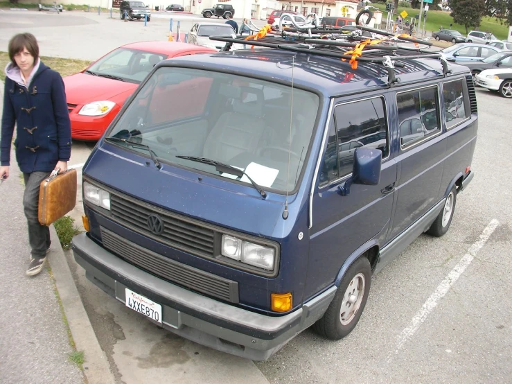 a person standing next to a van in a parking lot