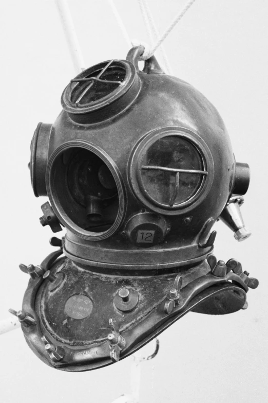 an old diving mask hanging from a ceiling