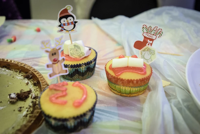 decorated cupcakes with animal and candy decorations