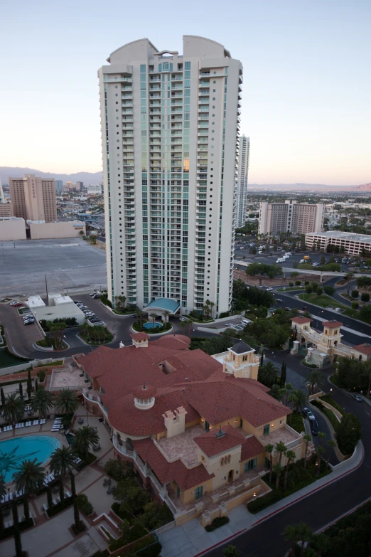 a large white and tan building some water buildings