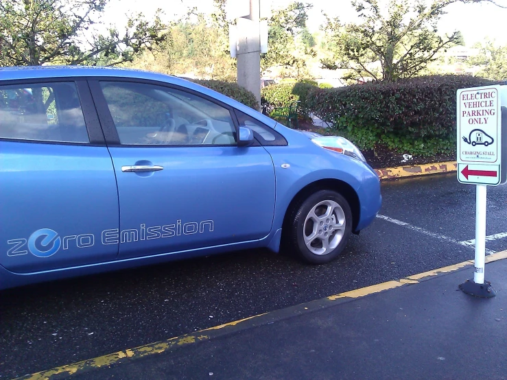 an electric blue car on the side of the road