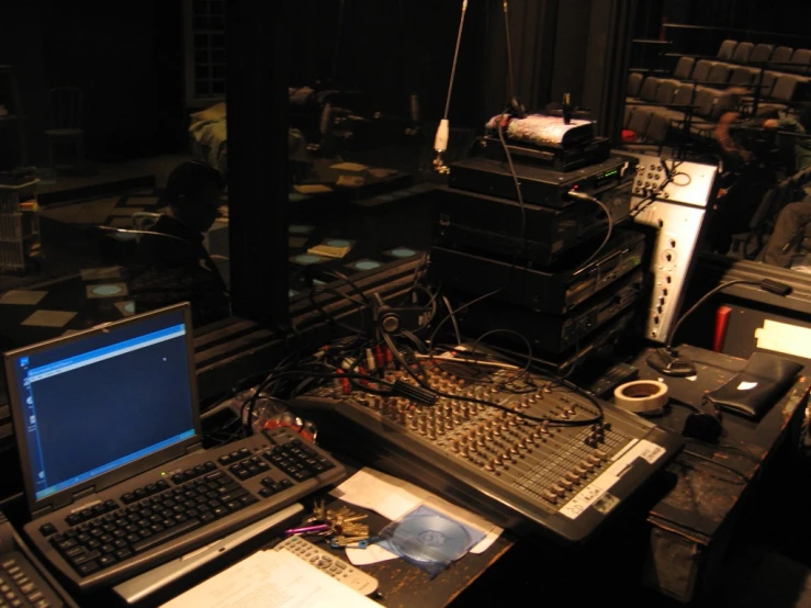 electronic equipment are sitting on a desk, while others work