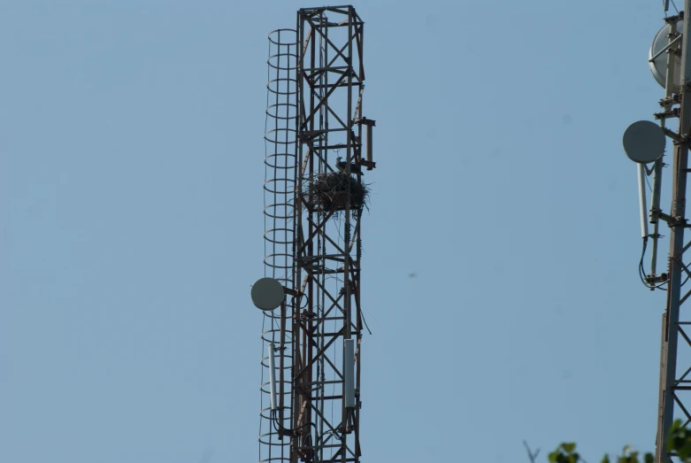 three metal objects are sitting on top of the tower