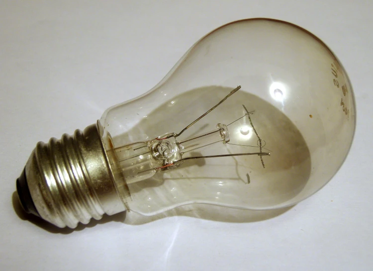 a small lightbulb is on the floor with a white background