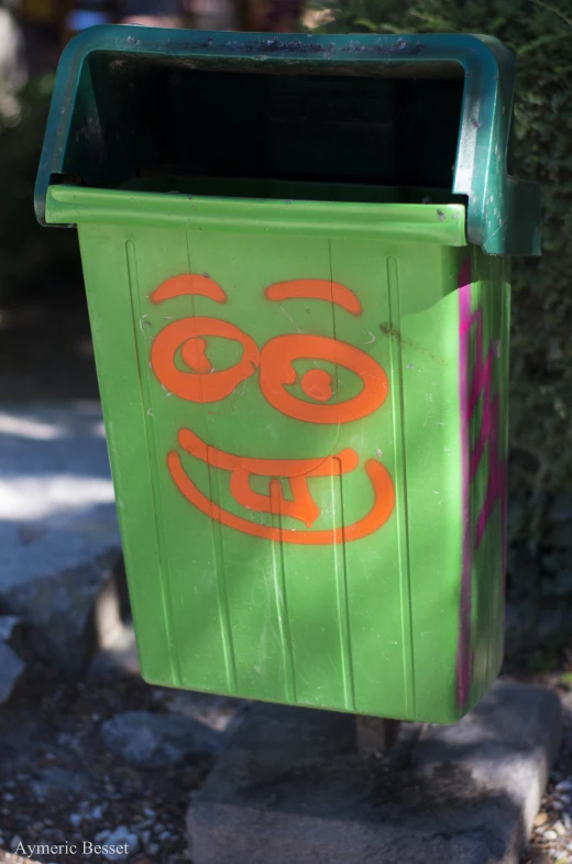 a green box with a face drawn on the side