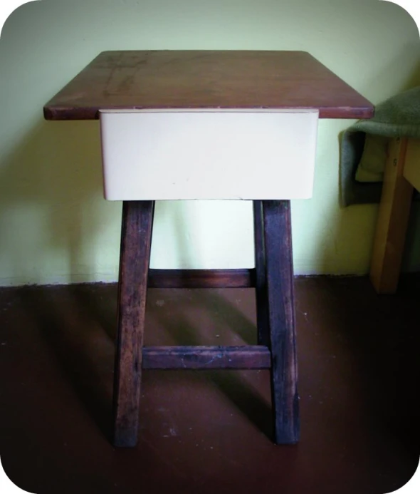 a wooden stool with an old - fashioned counter underneath it