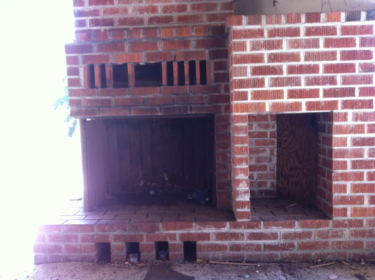 a brick fire place with multiple openings on top