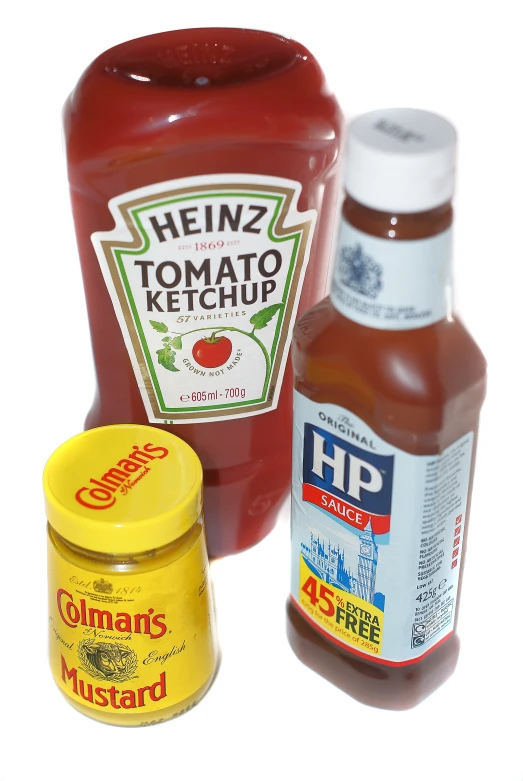 some different types of ketchup sitting on top of a white table