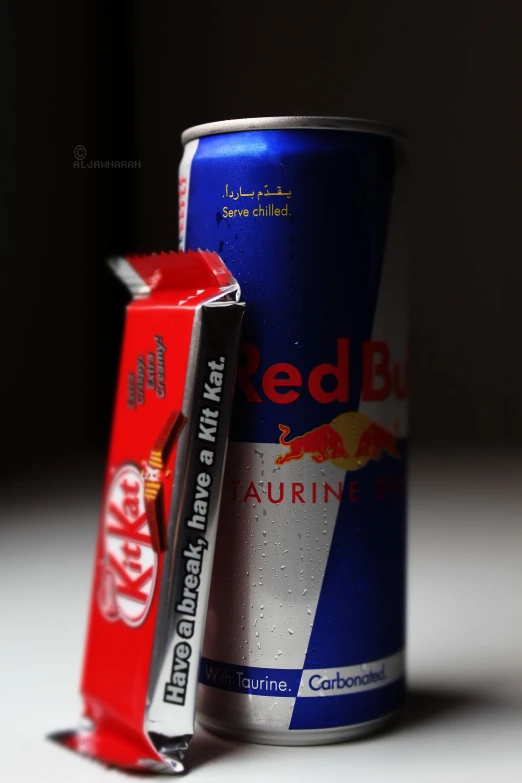 the cans of red bull energy drink and candy bar are shown