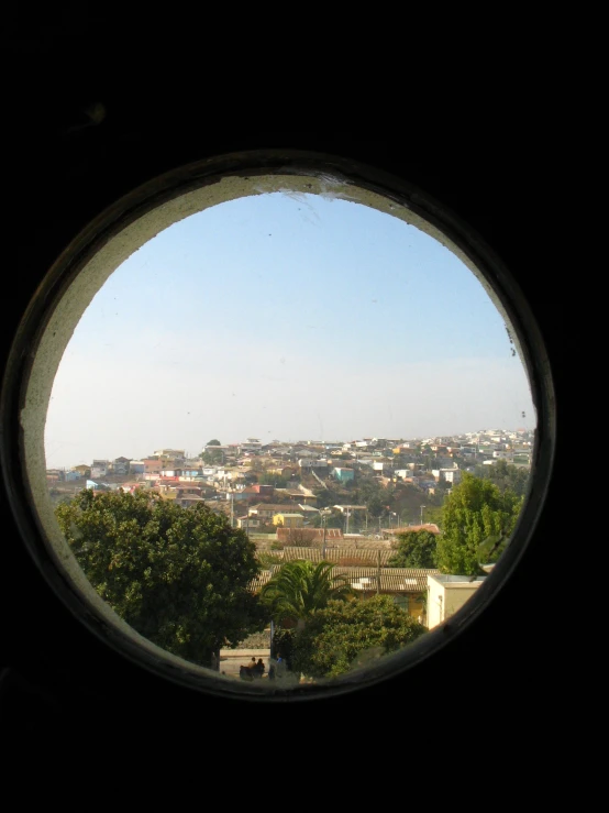 a view of a city taken from inside an old building