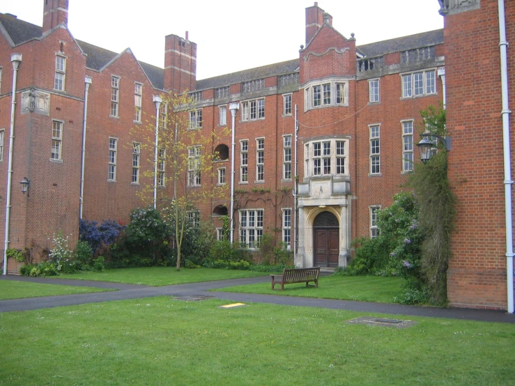 a building with lots of windows and green grass