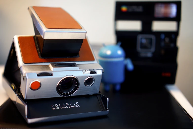 an old polaroid camera on a small stand