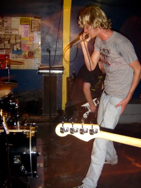 a man standing in a recording studio with a guitar