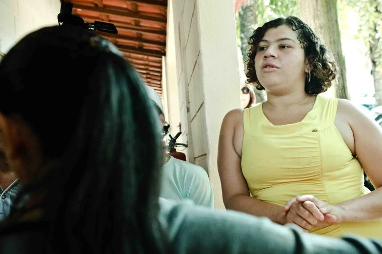 woman sitting with hand folded in front of her